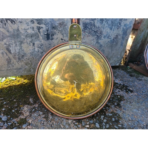 3 - Antique copper and brass bed warming pan with embossed lid with intricate decorative patterns.