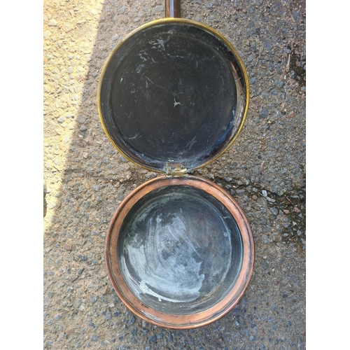 3 - Antique copper and brass bed warming pan with embossed lid with intricate decorative patterns.