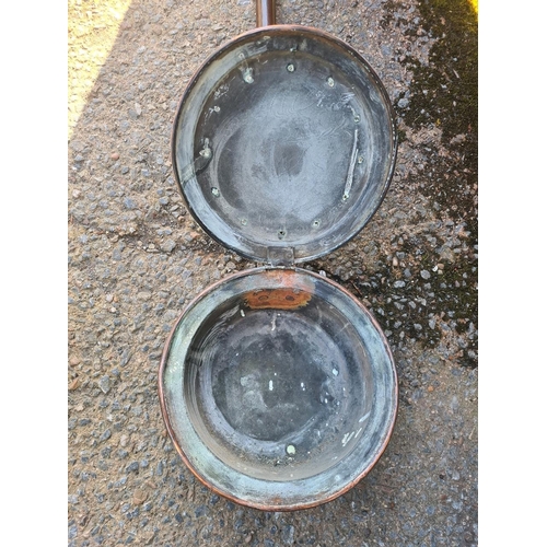 4 - Victorian copper bed warming pan with a repoussé pattern and punched holes to allow heat to escape.
