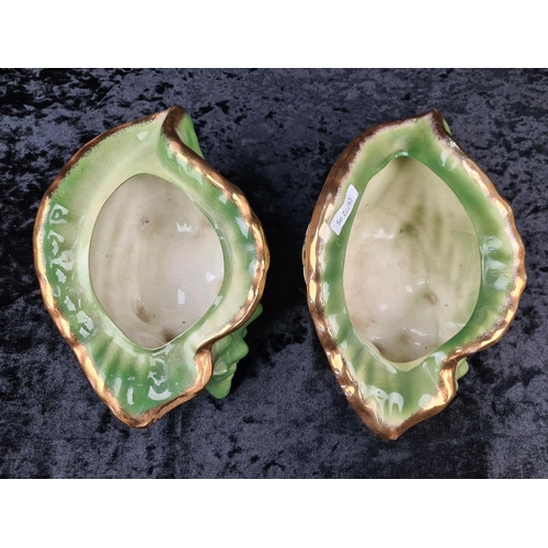 41 - Pair of kitsch Victorian-style decorative ceramic planters shaped like conch shells, with a green gl... 