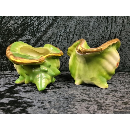 41 - Pair of kitsch Victorian-style decorative ceramic planters shaped like conch shells, with a green gl... 