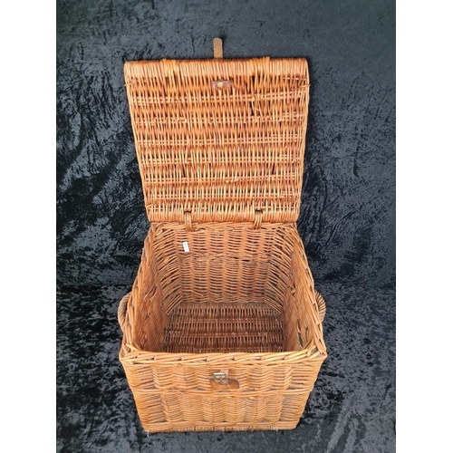 85 - Square wicker storage basket with handles and leather fastening. Approx H39 x W37 x D37cm.