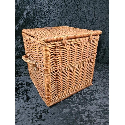85 - Square wicker storage basket with handles and leather fastening. Approx H39 x W37 x D37cm.