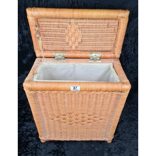 87 - Rattan/wicker rectangular laundry basket with lining and metal hinges. Approx H51cm.