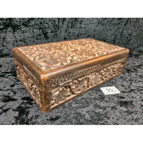95 - 1930s Indonesian wooden coffret carved with an intricate floral and leaf design and a vintage leathe... 