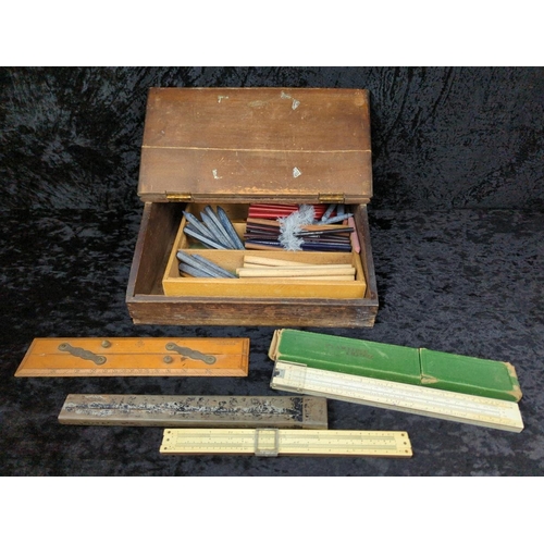 100 - Antique wooden writing slope filled with vintage writing implements and mathematical instruments.