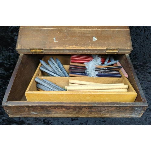 100 - Antique wooden writing slope filled with vintage writing implements and mathematical instruments.