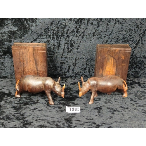 108 - Pair of late 1950s hand-carved hardwood rhino bookends (one has slight damage to tusk), and a little... 