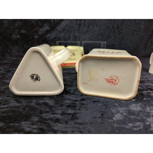 126 - Four vintage Bell's scotch whisky jugs, and two Bell's ashtrays.