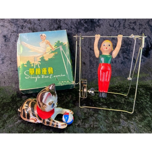 137 - Two vintage tinplate toys, cat with ball made in Japan and 'single bar excercise', boxed, made in Ch... 
