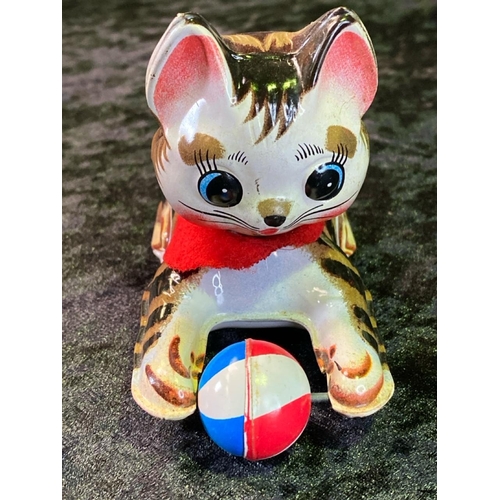 137 - Two vintage tinplate toys, cat with ball made in Japan and 'single bar excercise', boxed, made in Ch... 