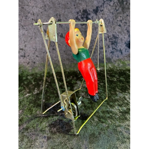 137 - Two vintage tinplate toys, cat with ball made in Japan and 'single bar excercise', boxed, made in Ch... 