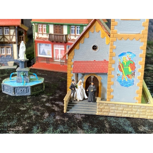 159 - H0 gauge plastic train layout models, German style pubs, shops and a church wedding! Total of seven ... 
