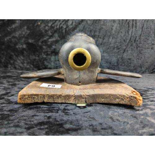 64 - Anglo-Indian carved ebony elephant head wall plaque, on a mahogany backboard and brass candle holder... 