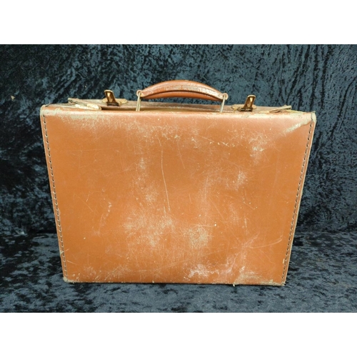 71 - Two vintage brown leather suitcases - largest by Revelation with remains of address labels to top, a... 