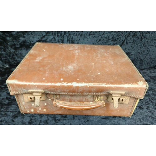 71 - Two vintage brown leather suitcases - largest by Revelation with remains of address labels to top, a... 