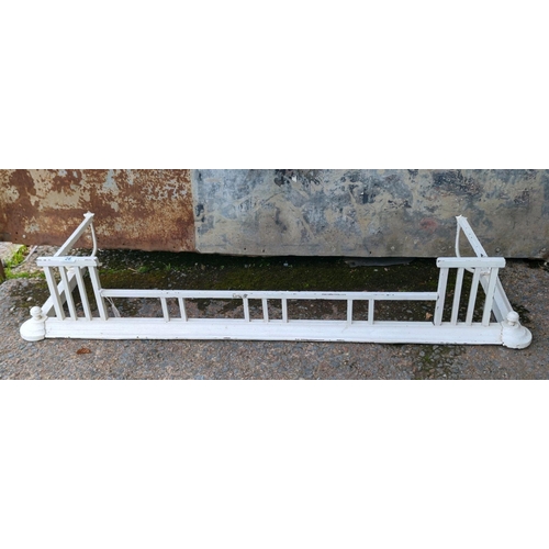 28 - Large old white-painted metal fireplace fender with curved ends and finials. Approx H23 x W123cm.