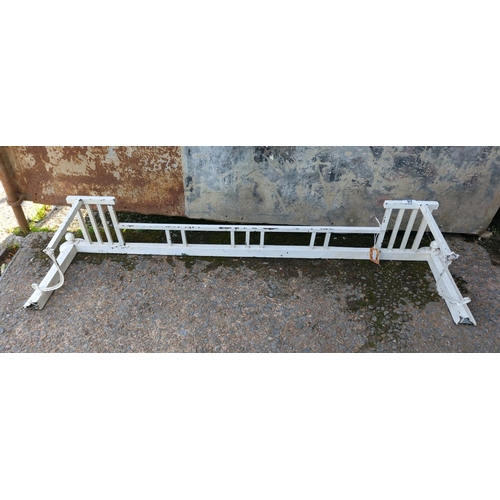 28 - Large old white-painted metal fireplace fender with curved ends and finials. Approx H23 x W123cm.