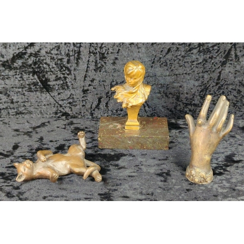 36 - Trio of metalware ornaments - brass woman’s head, a bronze hand a metal relaxing cat on a base. Tall... 