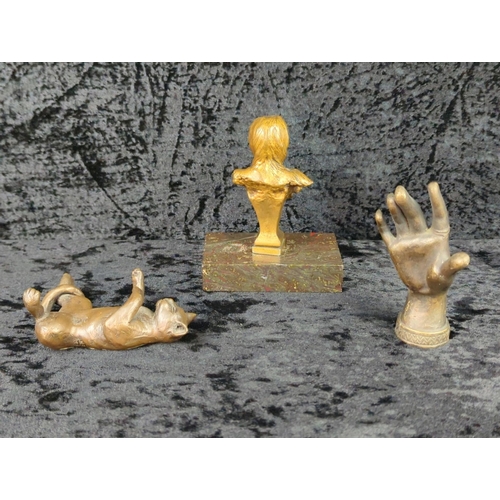 36 - Trio of metalware ornaments - brass woman’s head, a bronze hand a metal relaxing cat on a base. Tall... 