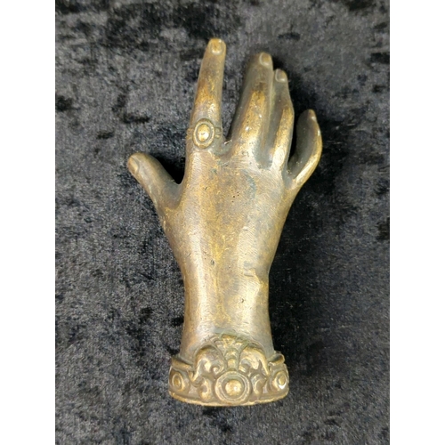 36 - Trio of metalware ornaments - brass woman’s head, a bronze hand a metal relaxing cat on a base. Tall... 