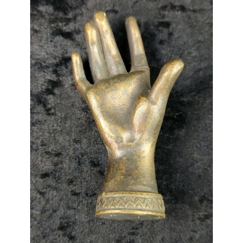 36 - Trio of metalware ornaments - brass woman’s head, a bronze hand a metal relaxing cat on a base. Tall... 