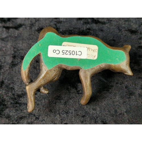 36 - Trio of metalware ornaments - brass woman’s head, a bronze hand a metal relaxing cat on a base. Tall... 
