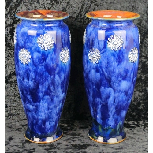 49 - Pair of early 20th century Royal Doulton vases with deep blue glaze and white relief flowers. Each a... 