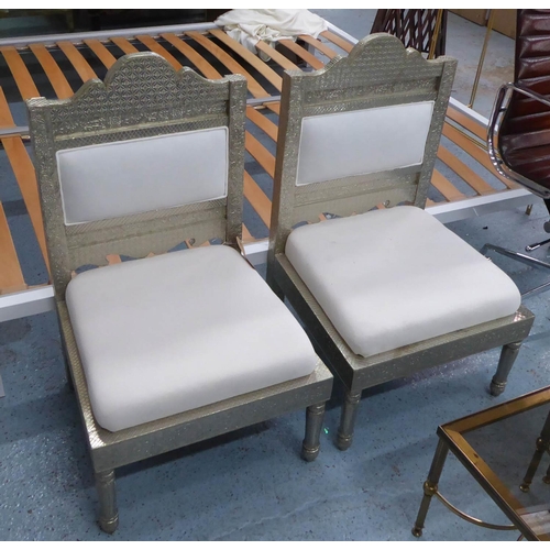 127 - INDIAN MANDAP CHAIRS, a pair, repoussè with white fabric upholstery, 93cm H. (2)