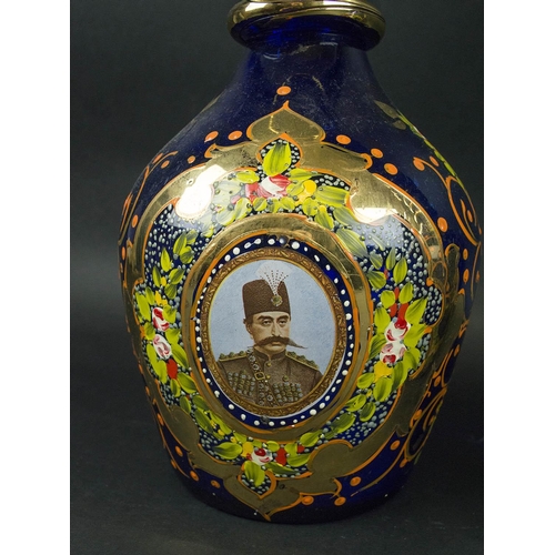 403 - NASSER AL DINE SHAH QAGAR DECANTERS, a pair, blue ground with portrait in cartouche handpainted foli... 