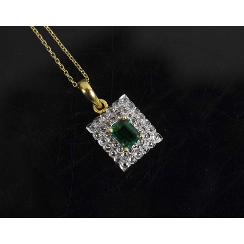 422 - AN EMERALD AND DIAMOND PENDANT, set to the centre with a rectangular shaped emerald within two rows ... 