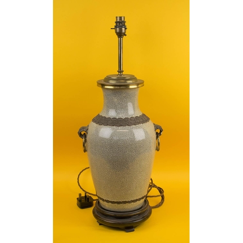 565 - TABLE LAMP, Chinese ceramic of vase form with brass rings and hardwood stand. (slight faults)
