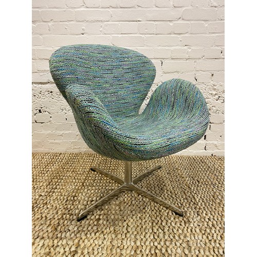 35 - AFTER ARNE JACOBSEN SWAN CHAIR, polished aluminum swivel base, upholstered in designers guild fabric... 