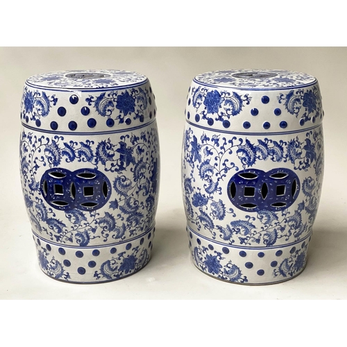 572 - CHINESE GARDEN STOOLS, a pair, blue and white ceramic, barrel shaped and pierced, 46cm H. (2)