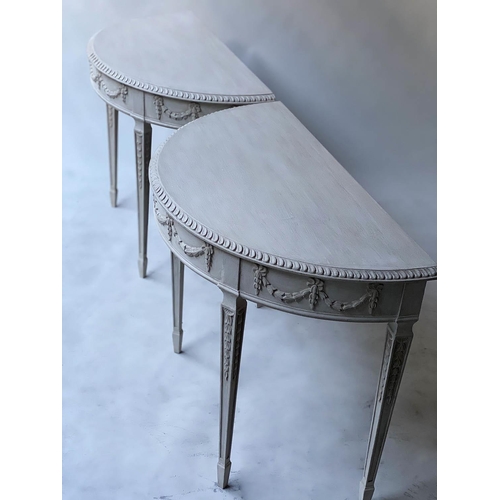 598 - CONSOLE TABLES, a pair, George III design, Robert Adam style demi lune grey painted with ribbon swag... 