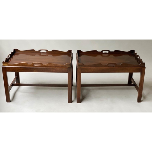 595 - TRAY TABLES, a pair, George III design, mahogany, each rectangular handle pierced, on stands, 76cmn ... 