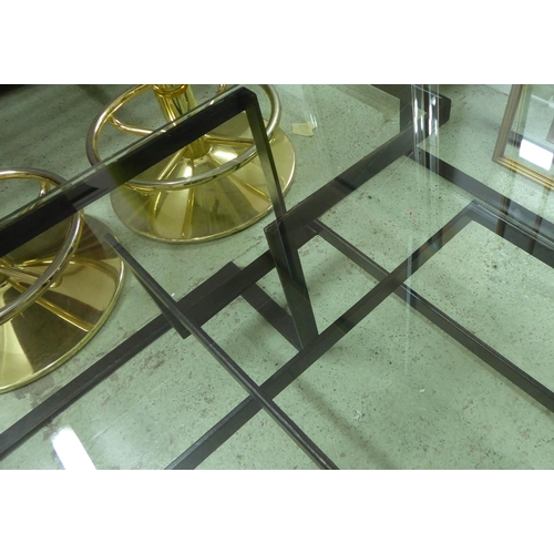 34 - LOW TABLE, the glass top on a metal base of geometric form, 80cm D x 120cm W x 38cm H.