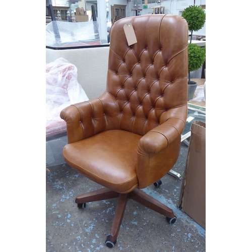 47 - DESK CHAIR, swivel in brown leather with a high buttoned back, 126cm H x 74cm W.
