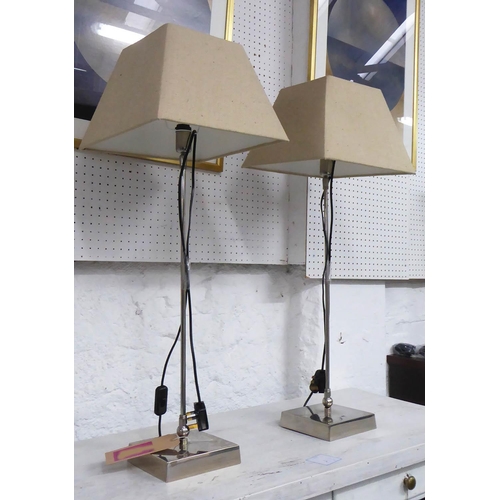 50 - PORTA ROMANA LAMPS, a pair, slender polished metal columns with linen shades, 80cm H. (2)