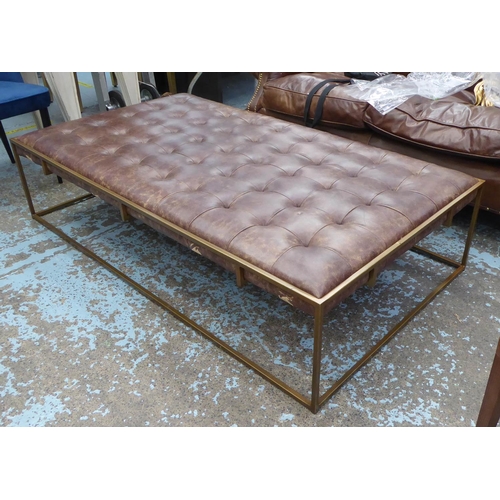 38 - OKA WALLACE COFFEE TABLE/OTTOMAN, brass coloured framed with a padded, deep buttoned top upholstered... 