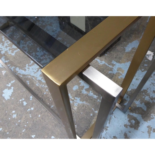 84 - CONSOLE TABLE, the smoked glass top on a metal two tone base, 41cm D x 77cm H x 130cm W.