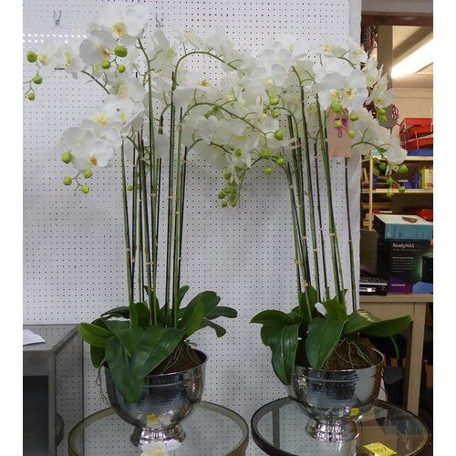 60 - FAUX ORCHIDS, a set of two, in hammered metal containers, each approx 115cm H.