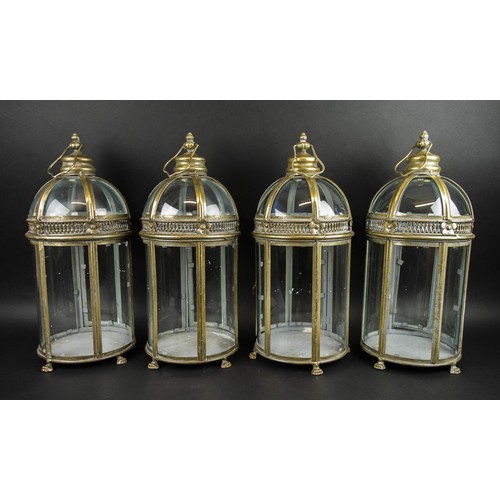 589 - STORM LANTERNS, a set of four, gilt metal and glass, 55cm H. (4)