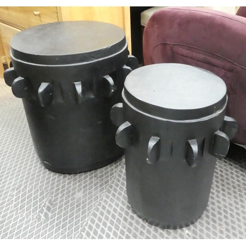 4 - DRUM TABLES, a graduated pair, ebonised finish, 57cm H x 52cm diam.