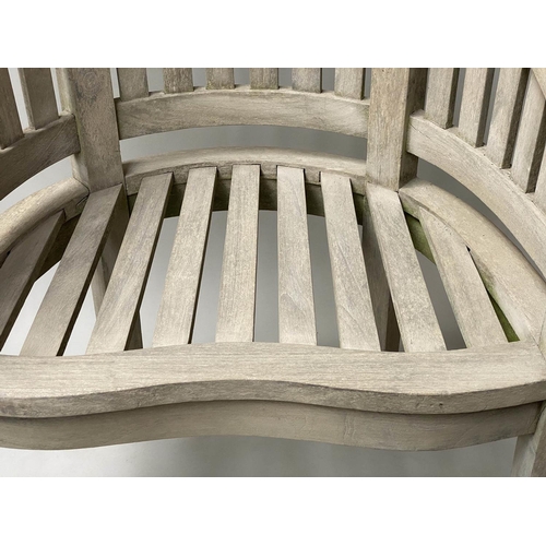 627 - 'BANANA' GARDEN ARMCHAIRS, a pair, weathered teak each with bow back together with a 'Lister' low ta... 