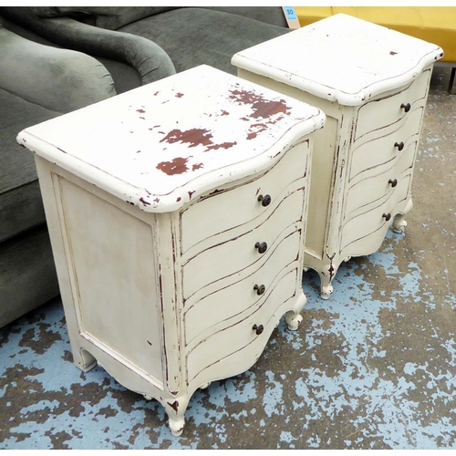 31 - BEDSIDE CHESTS, a pair, serpentine fronted, distressed cream painted, each with four drawers, 52cm W... 