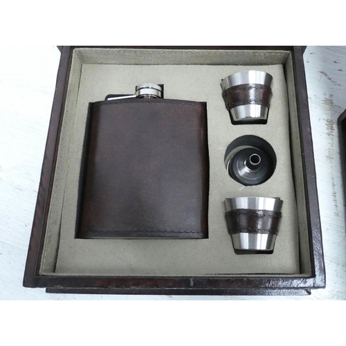 136 - HIP FLASK SETS, a pair, both in tan leathered boxes, 19cm x 19.5cm x 6cm. (2)