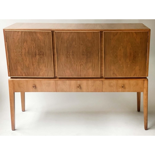 42 - MANNER OF A. COX SIDEBOARD, 1970's figured walnut  with three drawers and three doors with tall supp... 