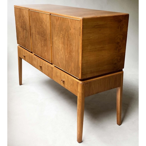 42 - MANNER OF A. COX SIDEBOARD, 1970's figured walnut  with three drawers and three doors with tall supp... 