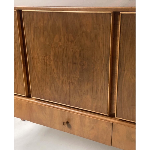 42 - MANNER OF A. COX SIDEBOARD, 1970's figured walnut  with three drawers and three doors with tall supp... 